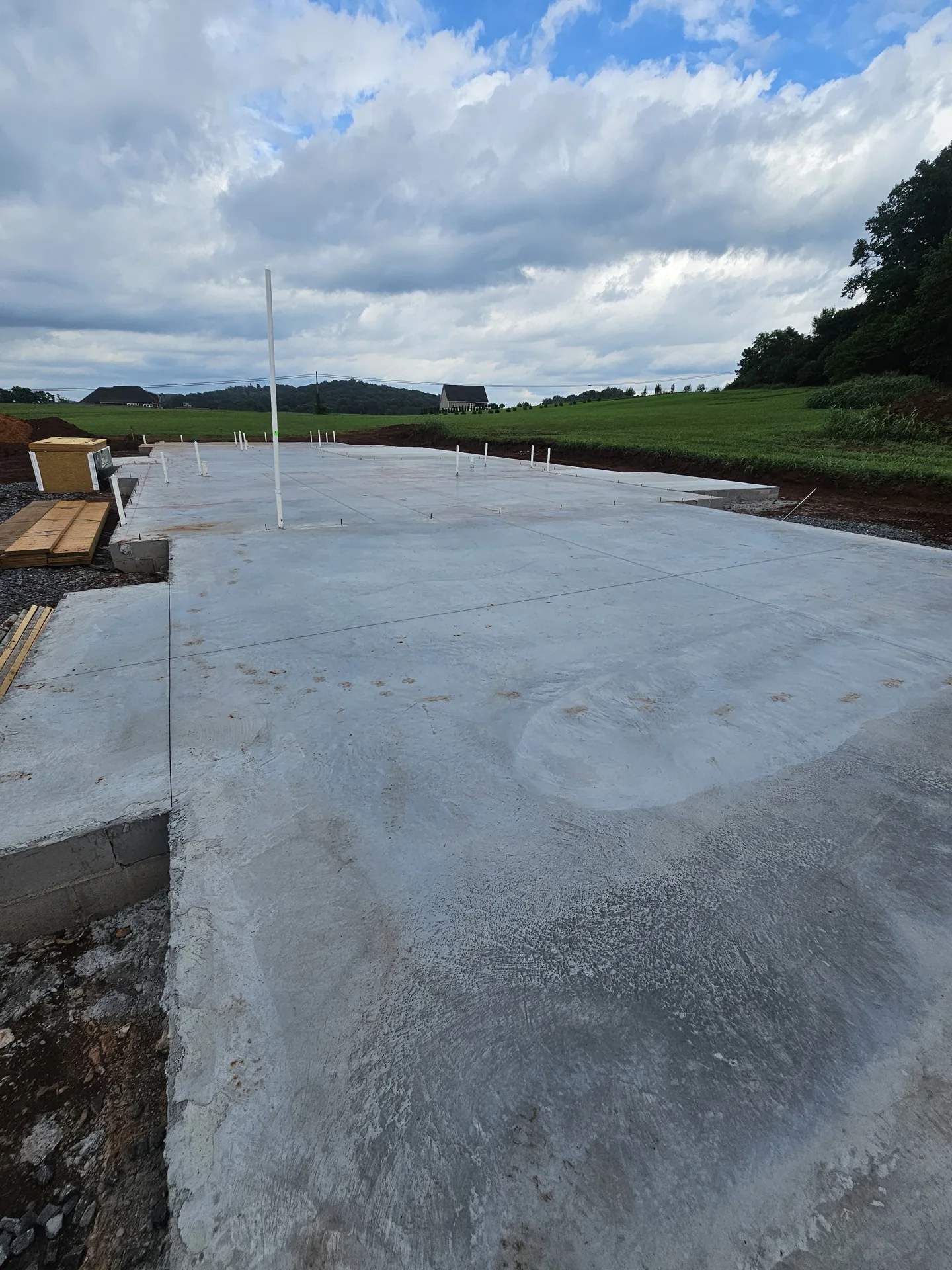 Concrete building slab with service pipes in place.